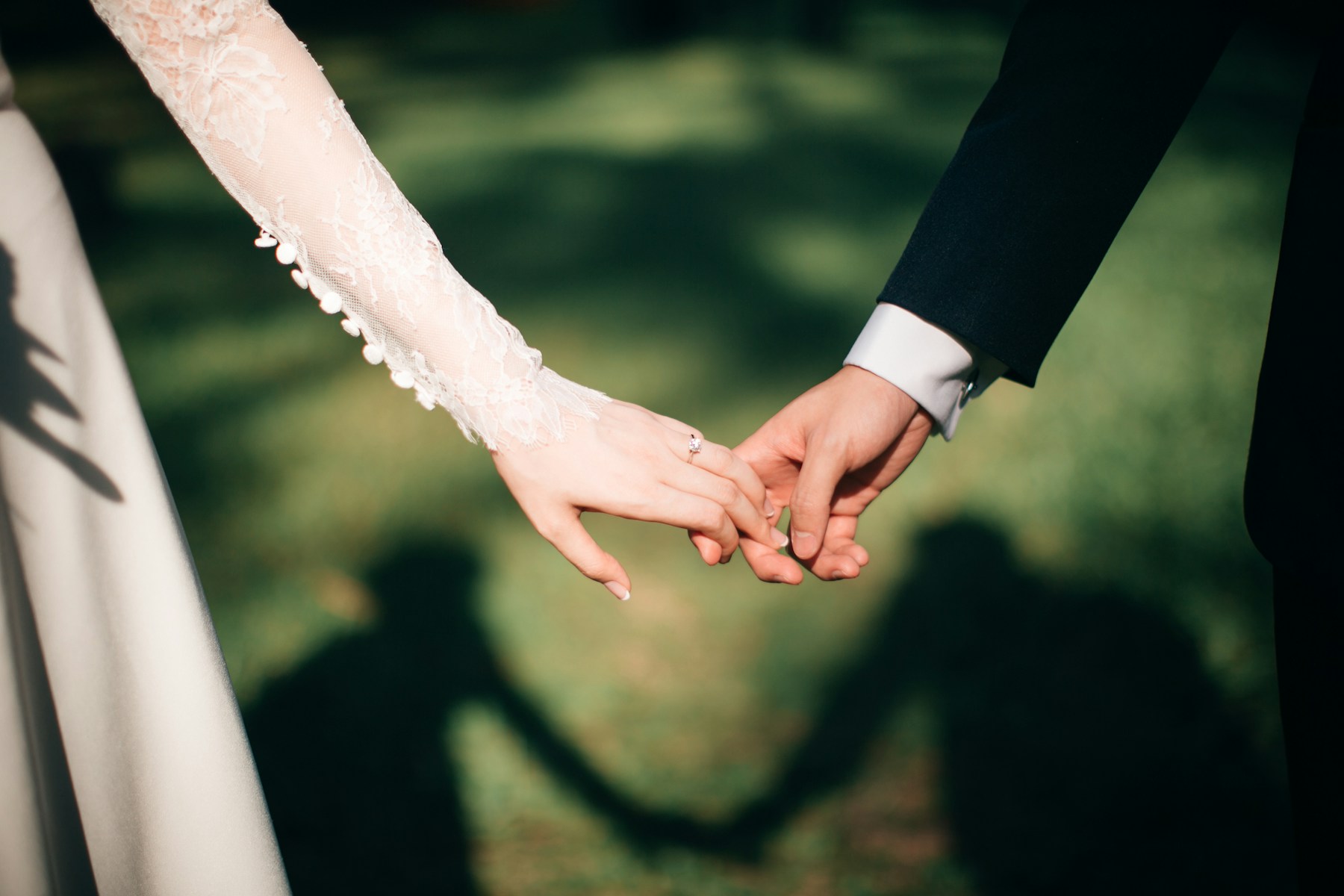 Mina and Parviz holding hands during an evening walk